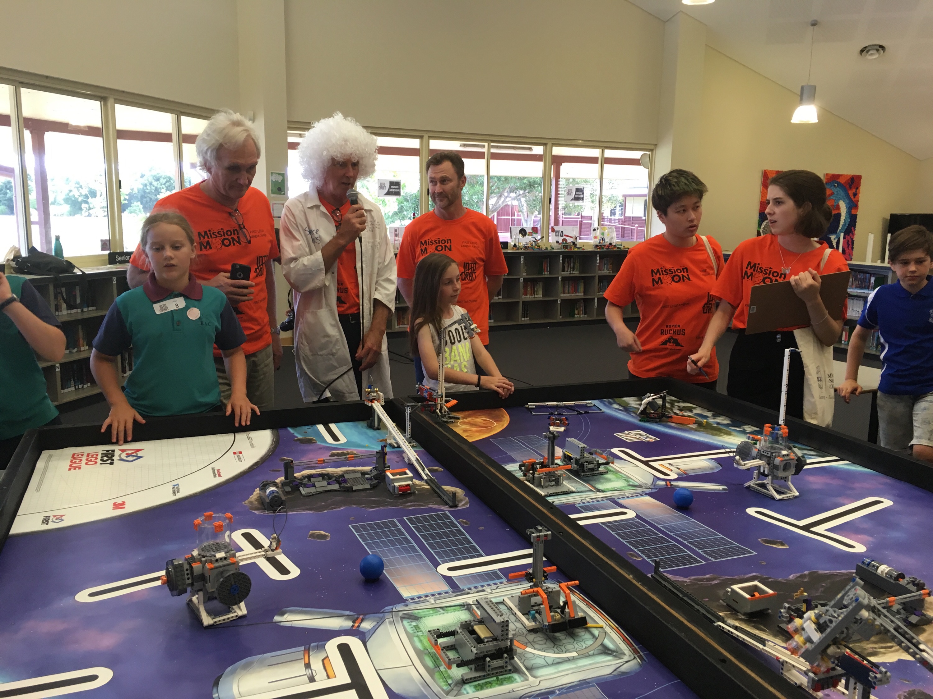 Image of people looking at a table of lego models